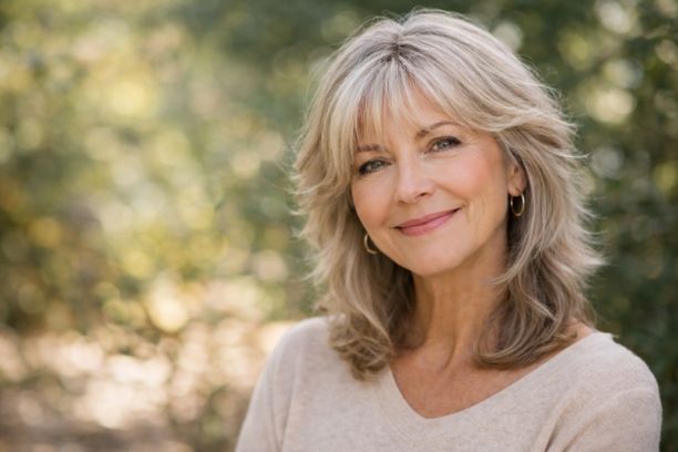 Soft shag haircut for women over 60 with fine gray hair and natural layered volume